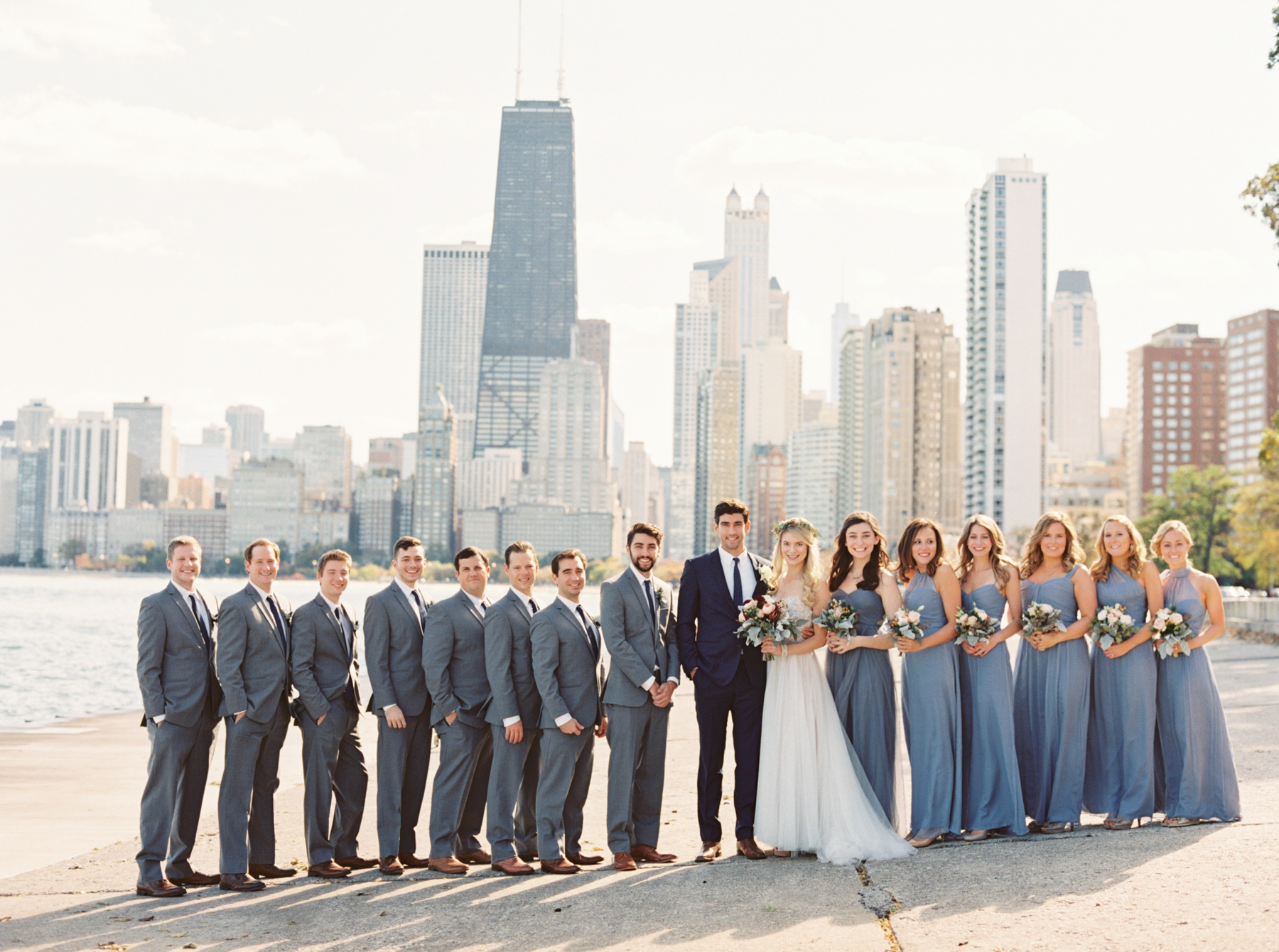 bride, groom and bridal party pose in front of Chicago skyline photo bry Chicago Wedding Photographer Kati Rosado