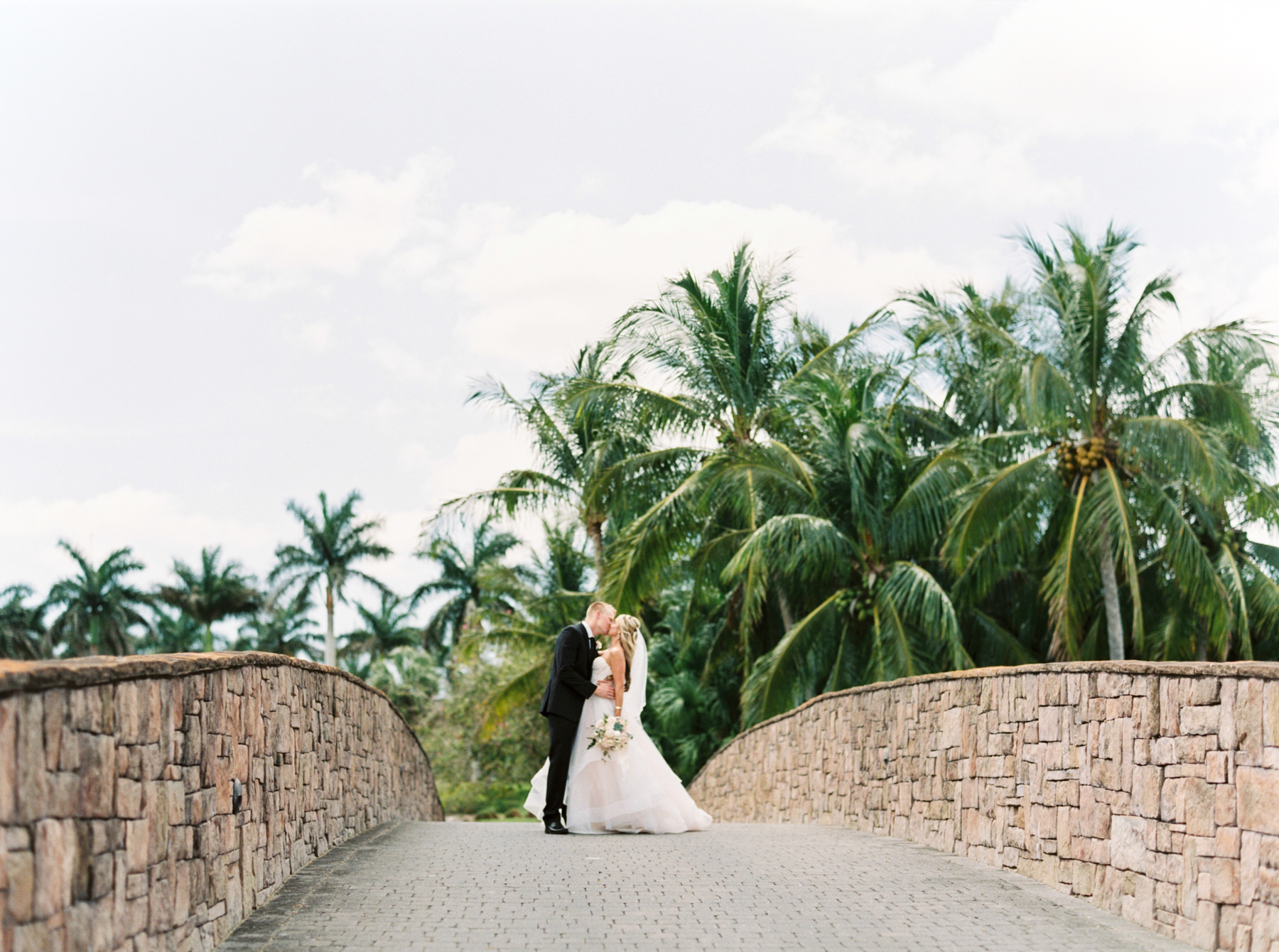 bride and groom portrait with palm trees background at Naples Florida Wedding 