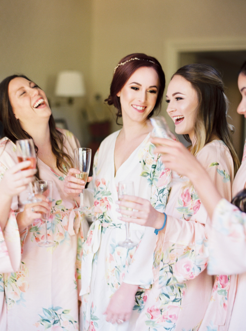 bride and bridesmaids in floral robes laughing before Vinewood Plantation Wedding in Newnan GA