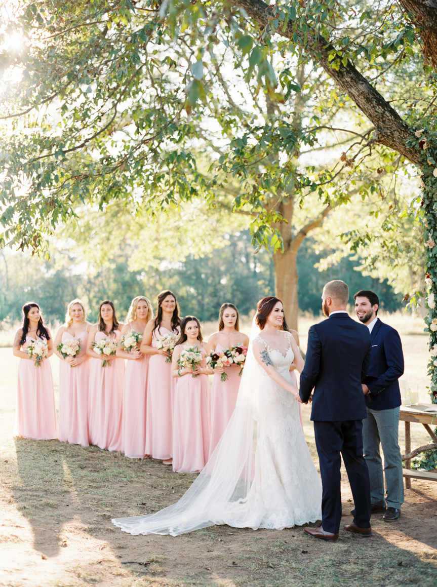 bridesmaids wearing pink at altar Vinewood Plantation Wedding in Newnan GA