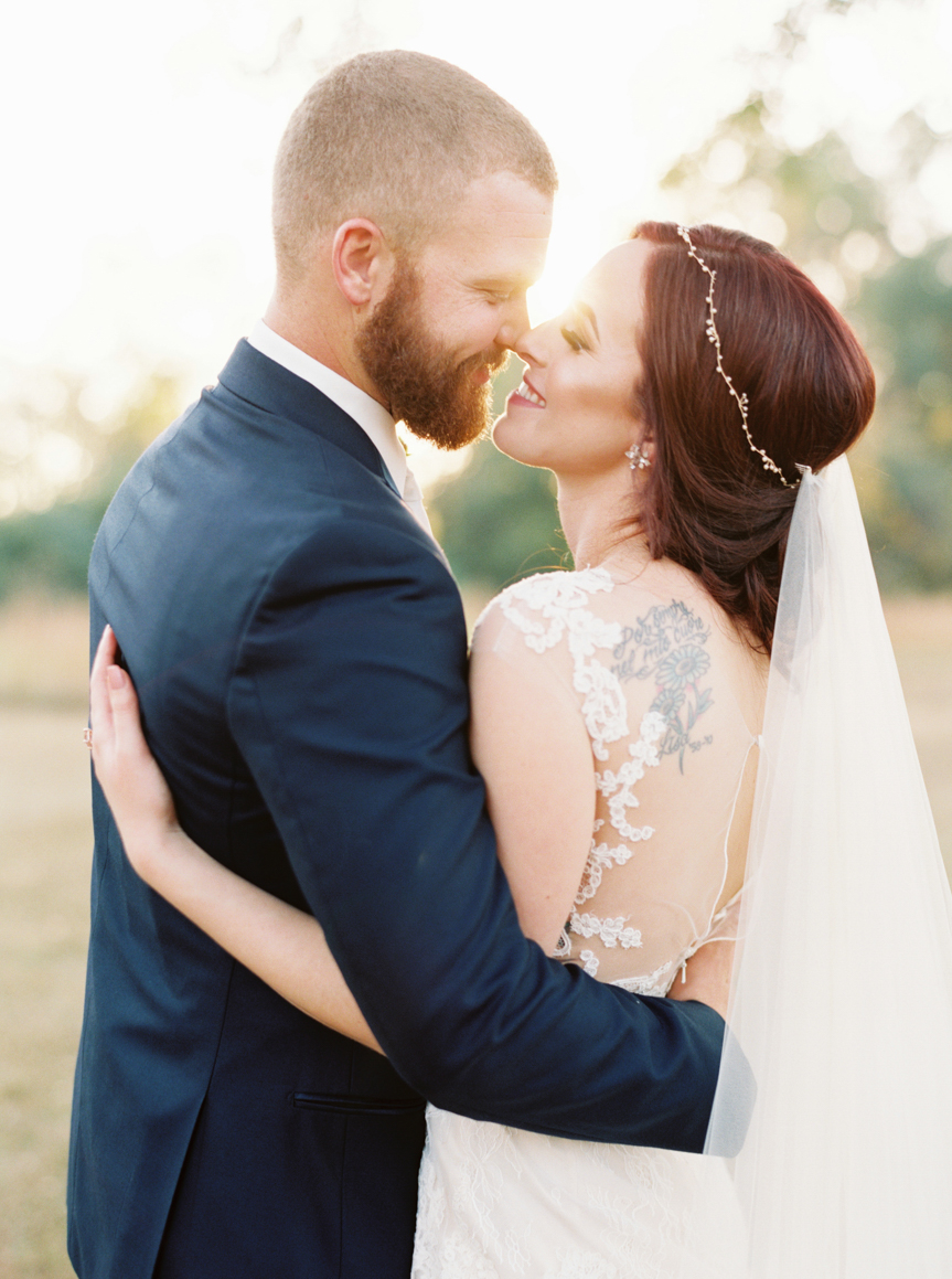 bride and groom embrace nose to nose Vinewood Plantation Wedding in Newnan GA