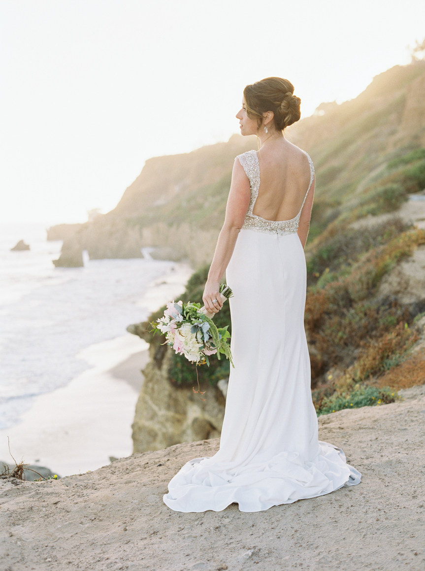 bridal portrait photos on cliff overlooking pacific ocean by Los Angeles Fine Art Wedding Photographer