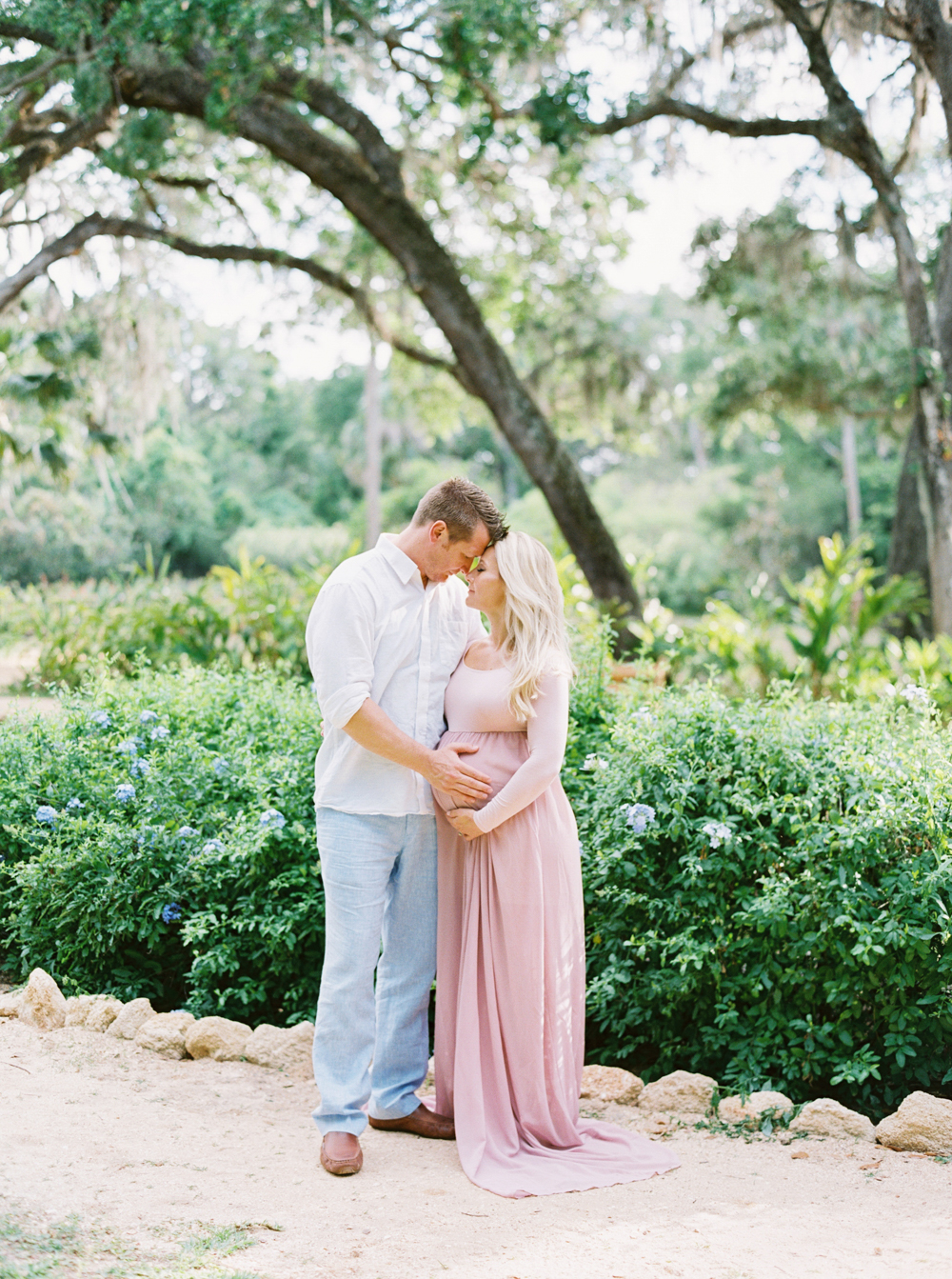beautiful mother to be wearing pink long flowy dress for Maternity and Newborn Sessions