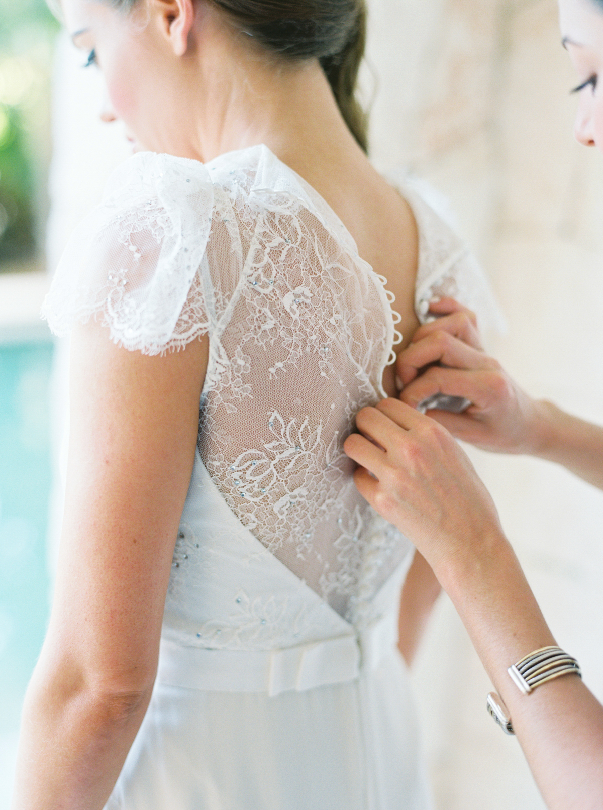 bride getting dressed photographed by Cancun Mexico Wedding Photographer Kati Rosado