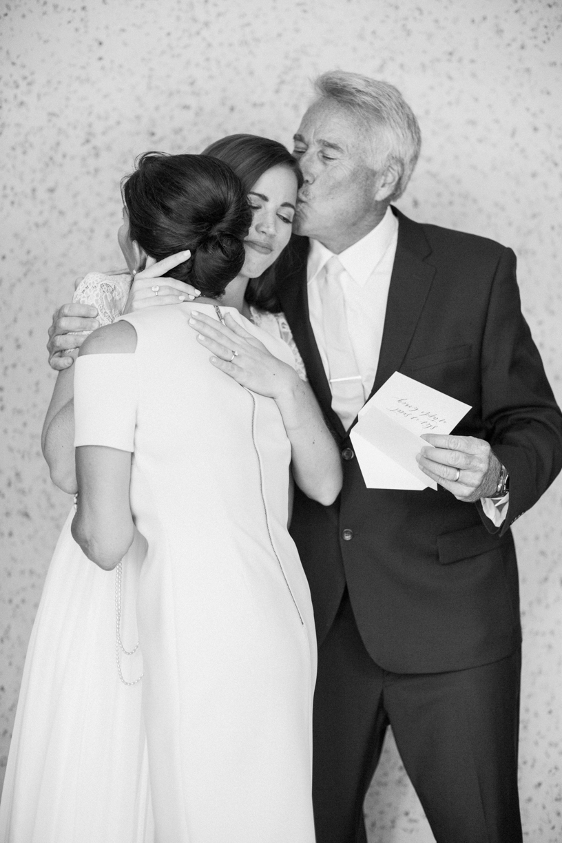wedding photographer captures dad kissing bride on head